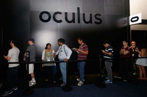 Game enthusiasts and industry personnel stand in line at the Oculus VR exhibit at the Annual Gaming Industry Conference E3 at th