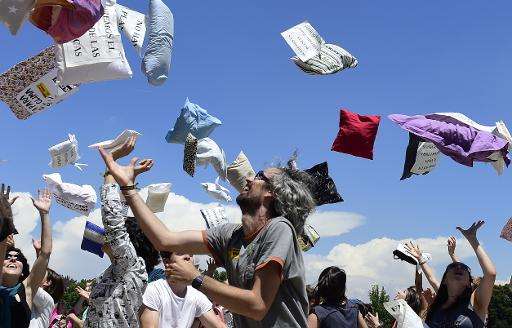 Greenpeace activists throw pillows in the air during an action dubbed &quot; Wake-up for the climate. Demand renewables NOW&quot