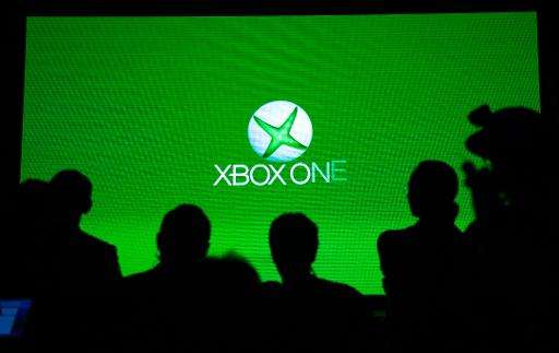 People look at a screen during the presentation of the Xbox One in Shanghai, China, on July 30, 2014
