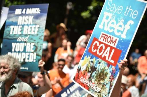 Protesters hold banners outside the headquarters of the Commonwealth Bank to say no to coal expansion on the Great Barrier Reef,