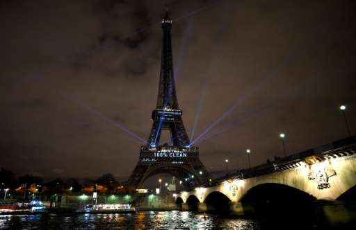 The Eiffel Tower lit up with green color and messages to prevent global warming during the first day of the United Nations clima