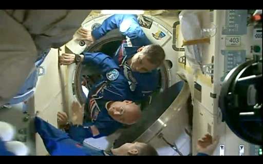 This March 28, 2015 still image from NASA TV shows American astronaut Scott Kelly (bottom) and Russian Mikhail Kornienko (top) e
