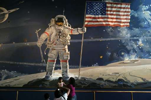 Visitors take photographs at the Smithsonian National Air and Space Museum in Washington, DC on August 31, 2012