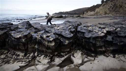 Workers clean up oil spill on California beaches by hand
