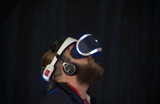 A visitor tries Sony's Project Morpheus virtual reality headset for PlayStation 4 ahead of the opening of the 55th IFA (Internat