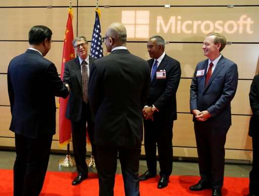 Chinese President Xi Jinping, left, shakes hands with Microsoft founder Bill Gates, second from left, as company CEO Satya Nadel