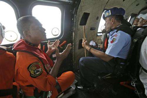 Divers enter water in search of wreckage from AirAsia jet