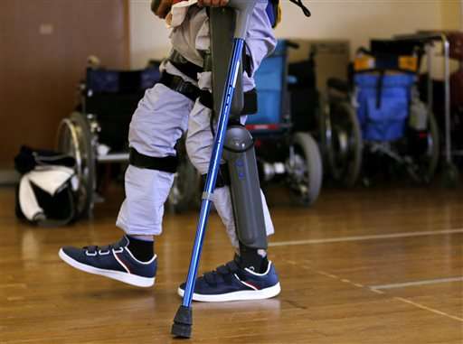 Exoskeleton that helps paralyzed walk faces barrier in Japan