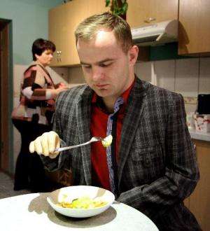 Martynas Girulis eats with his new bionic arm at his home in Pagegiai, Lithuania