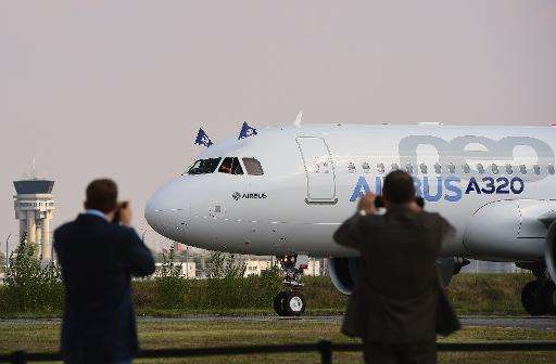 People take pictures of the Airbus A320neo on September 25, 2014 at Blagnac airport near Toulouse, after its first test flight