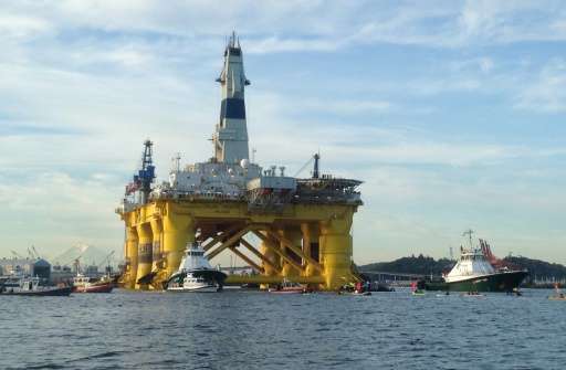 Greenpeace activists in kayaks try to block the departure of the Shell Oil &quot;Polar Pioneer&quot; rig platform as it moved fr