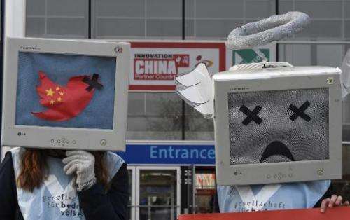 Demonstrators protest for freedom of opinion in China during the opening day of the CeBIT technology fair in Hanover, central Ge