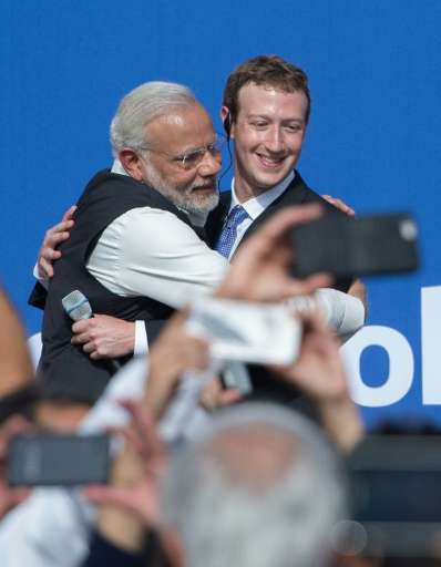 Indian Prime Minister Narendra Modi (L) hugs Facebook CEO Mark Zuckerberg after a meeting in California on September 27, 2015
