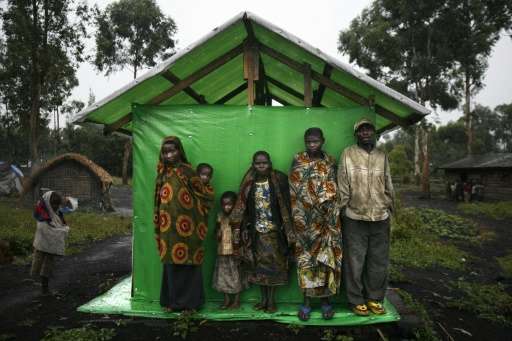 A picture taken on October 26, 2006 shows a group of pygmies sheltering from the rain in Mubambiro village, near Goma, Democrati
