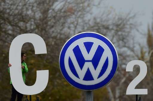 Greenpeace activists form a &quot;CO2&quot; sign around the Volkswagen logo outside the company's headquarters in Wolfsburg, Ger