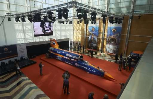 Visitors look at the Bloodhound Supersonic Car, a 135,000-horsepower car, at Canary Wharf in east London on September 24, 2015