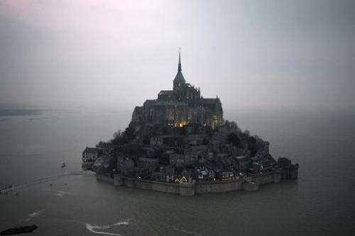 An aerial view of Mont-Saint-Michel surrounded by the sea during high tide on March 20, 2015