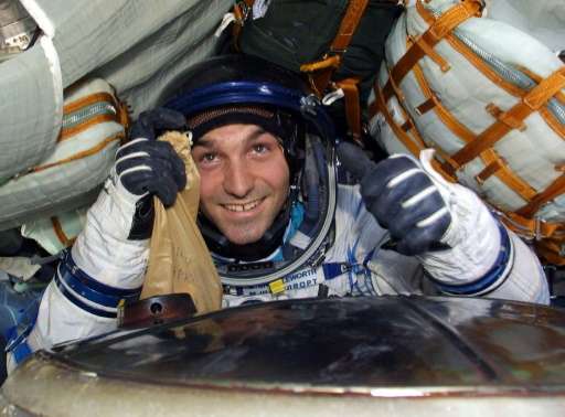 South African millionaire Mark Shuttleworth, the first African in space, gives the thumbs up inside the Soyuz capsule after land