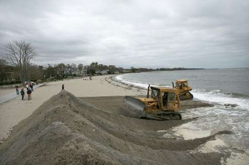 File picture shows earth movers building protective berms on Compo Beach in Westport, Connecticut ahead of approaching Hurricane