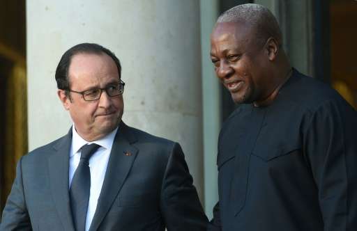 French President Francois Hollande (L) escorts Ghana's President John Dramani after a pre-COP 21 climate meeting on November 10,