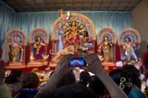 A Bangladeshi Hindu devotee takes photographs with his cell phone of the Durga pandal at the Dhakeshwari temple in Dhaka on Octo