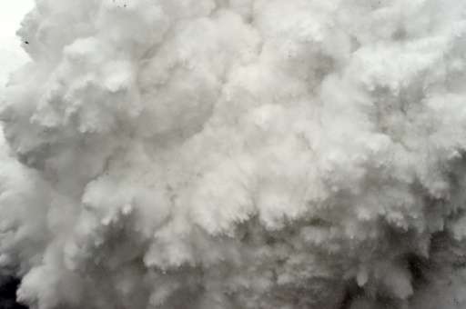 A cloud of snow and debris is captured April 25, 2015, just before it flattened part of Everest Base Camp in the Himalayas, wher