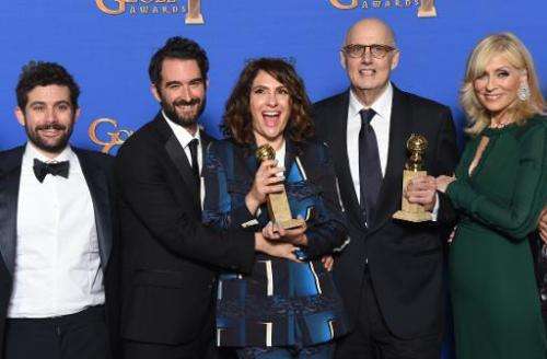Actor Jeffrey Tambor (2-R) and show creator Jill Soloway (C) holds the award for Best TV Series, Comedy or Musical for &quot;Tra