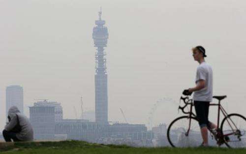A cyclist pictured at the top of Primrose Hill in London on April 3, 2014 as the city below lies shrouded in pollution