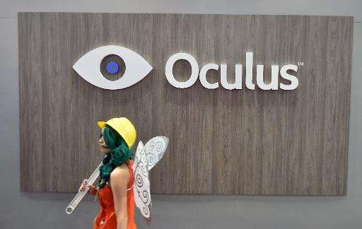 A girl in a costume walks by the Oculus booth at the Game Developers Conference in San Francisco, California on March 4, 2015