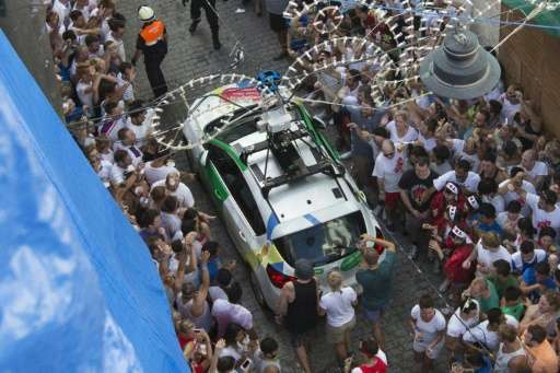 A Google car passes revellers during the annual &quot;Tomatina&quot; festivities in the village of Bunol, near Valencia on Augus