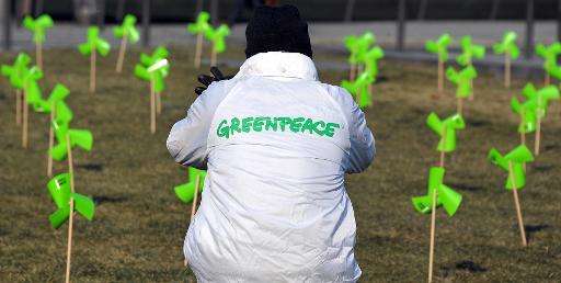 A Greenpeace activist sets miniature windmills in front of Strasbourg's railway station during an action aimed at increasing pub
