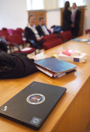 A lawyer's laptop with a sticker reading &quot; National Security Agency monitored device&quot; lies on a table in the courtroom