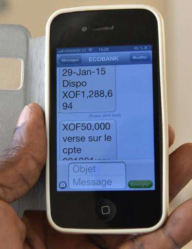 A man checks his account on his mobile phone on April 24, 2015 in Abidjan, Ivory Coast