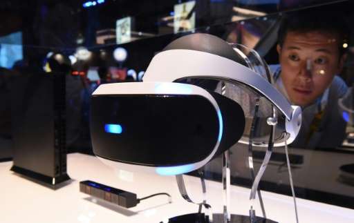 A man looks at Sony's virtual reality head gear &quot;PlayStation VR&quot; during the Tokyo Game Show in Chiba on September 17, 