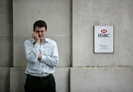 A man uses his mobile phone outside an HSBC bank branch in London