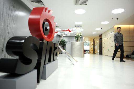 A man walks past the entrance to the offices of Sina Weibo, widely known as China's version of Twitter, in Beijing