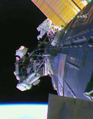 A NASA video images shows two American astronauts stepping stepped out on a spacewalk to prepare the International Space Station