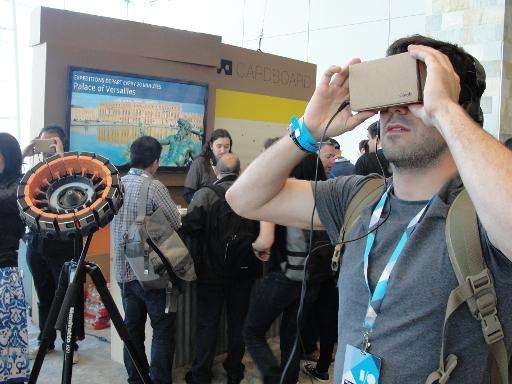 An attendee at Google's annual developers conference checks out cardboard virtual reality head gear, May 28, 2015 in San Francis
