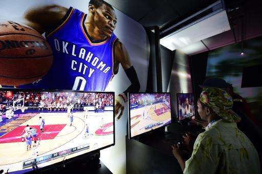 An attendee plays EA Sports &quot;NBA Live 16&quot;, with Russell Westbrook as the cover athlete, at the E3 Electronic Entertain