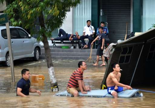 A new report says human-influenced climate change likely means more extreme weather events like the floods that hit Jakarta, Ind