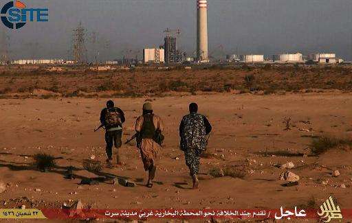 An image taken from jihadist media outlet Wilayat Trablus on June 9, 2015 allegedly shows Islamic State group fighters running t