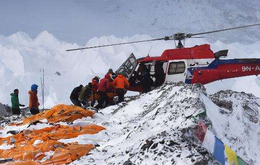An injured person is loaded onto a rescue helicopter at Everest Base Camp on April 26, 2015, a day after an avalanche triggered 