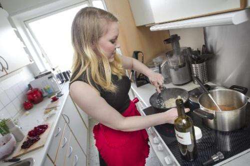 Anne Sofie Udklit Soerensen prepares a meal in her private kitchen in order to sell it on the DinnerSurfer website, one of a var