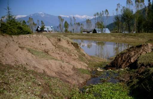 A partially dried up pond that irrigates paddy fields pictured in Chandigam village in the Lolab Valley in the foothills of the 