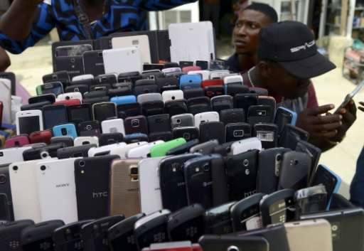 A phone vendor sits beside his wares in Lagos on April 24, 2015