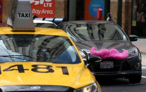 A San Francisco taxi competes alongside a car run by Lyft, an Uber-like online cab service that along with other forms of the &q