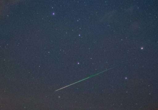 A shooting star crosses the night sky over Sieversdorf, eastern Germany, on August 11, 2015