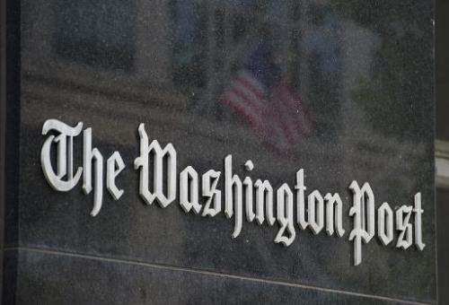 A sign hangs on the outside of the Washington Post building on August 6, 2013 in Washington, DC