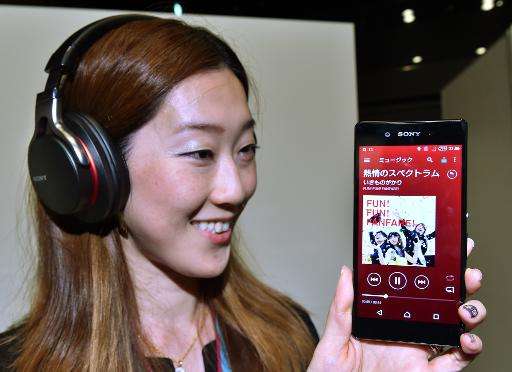 A Sony employee displays the new smartphone &quot;Xperia Z4&quot; at the company's headquarters in Tokyo on April 20, 2015