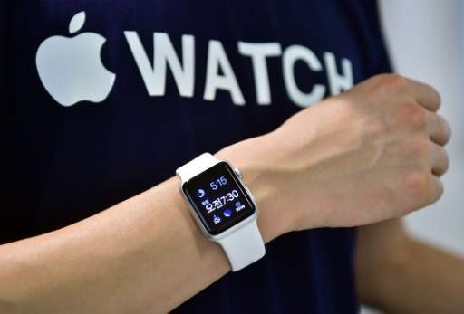 A South Korean employee shows the Apple Watch at an Apple shop in Seoul on June 26, 2015
